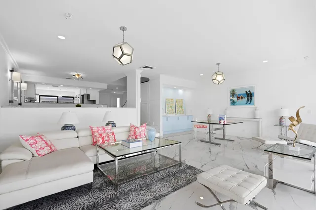 a living room with furniture and kitchen view
