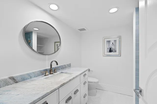 a bathroom with a shower a mirror and a sink