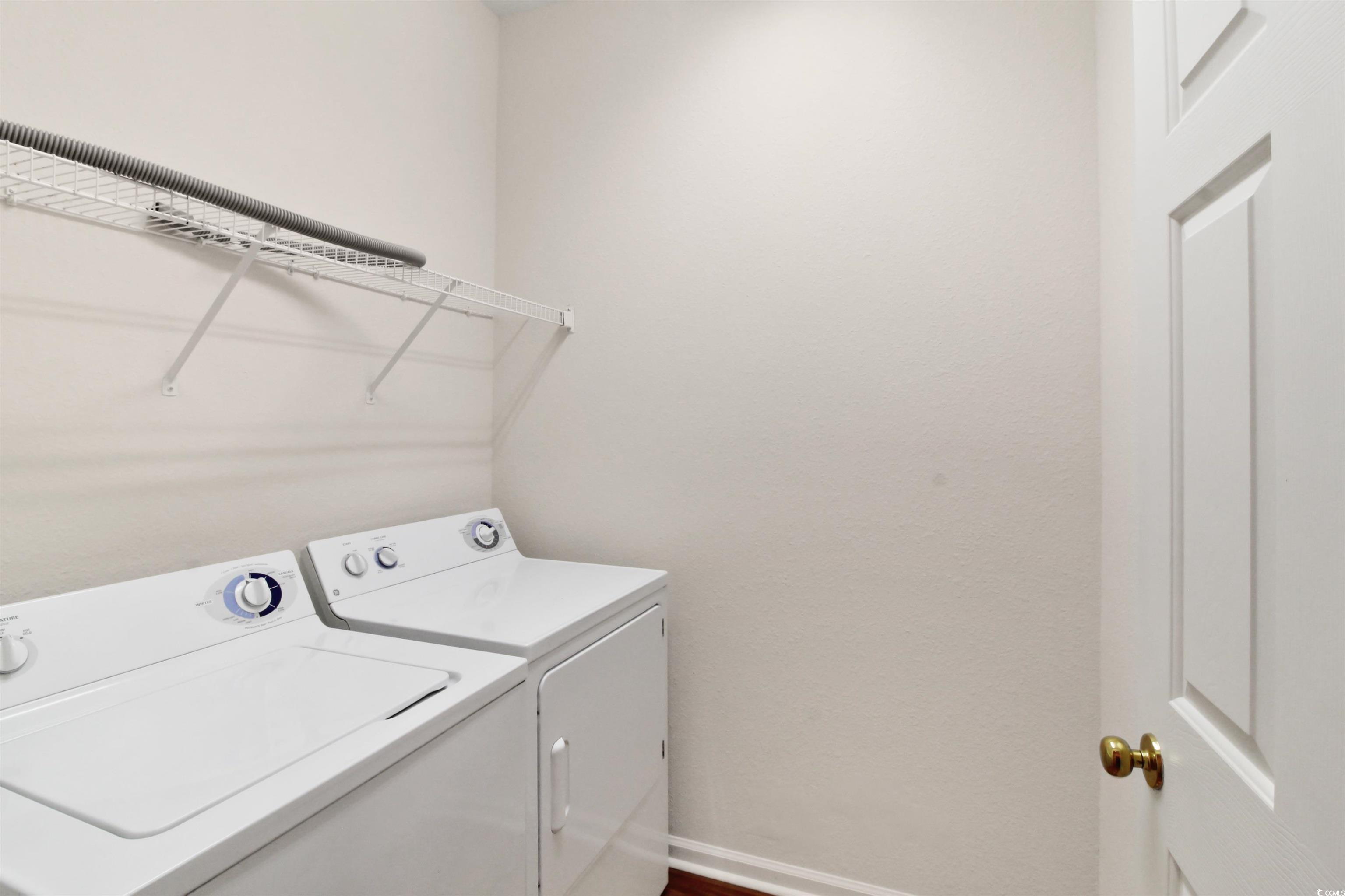 301 Nut Hatch Lane, Unit D Murrells Inlet, SC 29576 - Photo 9 of 40 Laundry area with baseboards and washing machine and clothes dryer