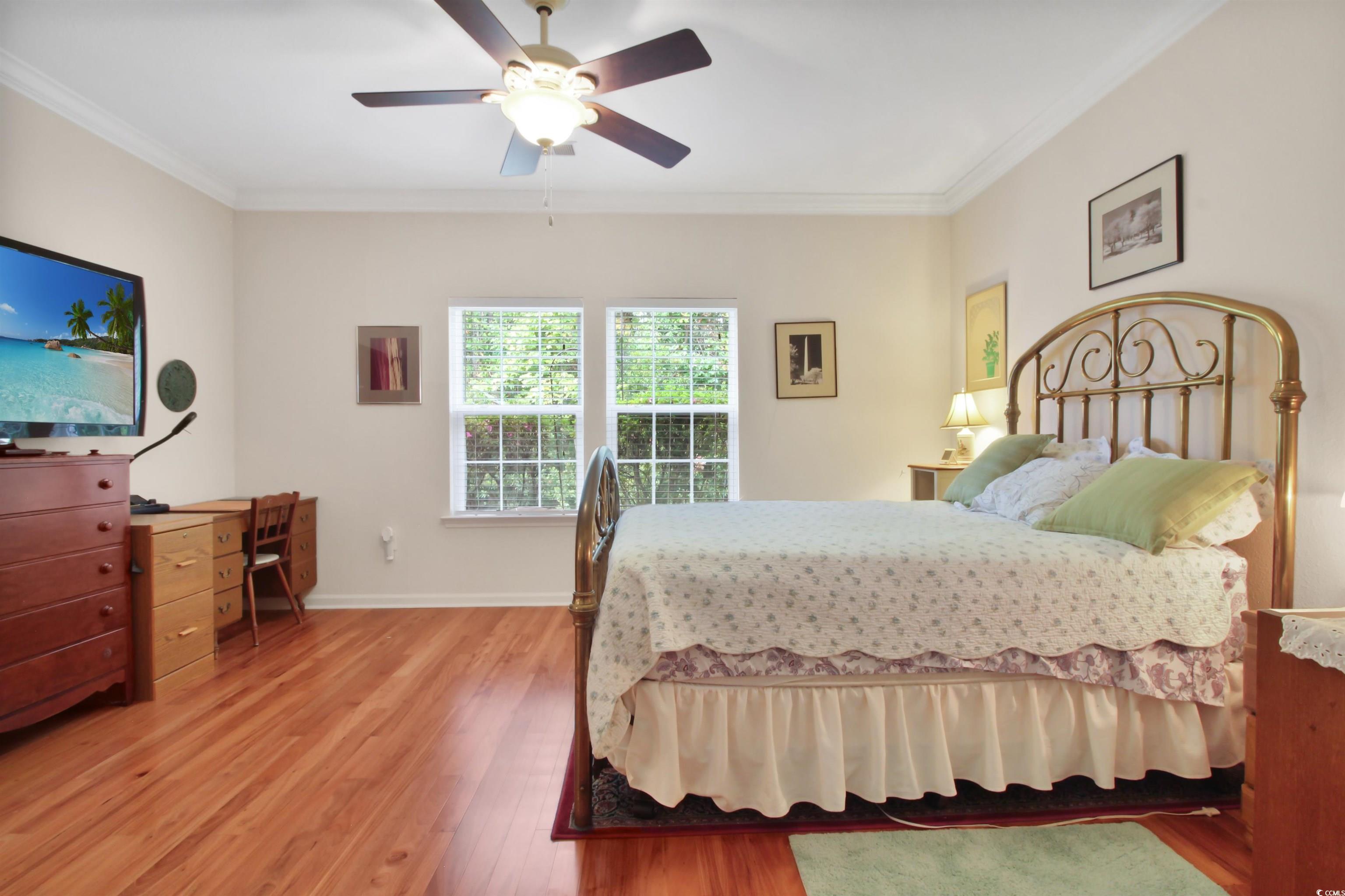 301 Nut Hatch Lane, Unit D Murrells Inlet, SC 29576 - Photo 15 of 40 Bedroom featuring crown molding, light wood-style flooring, and a ceiling fan