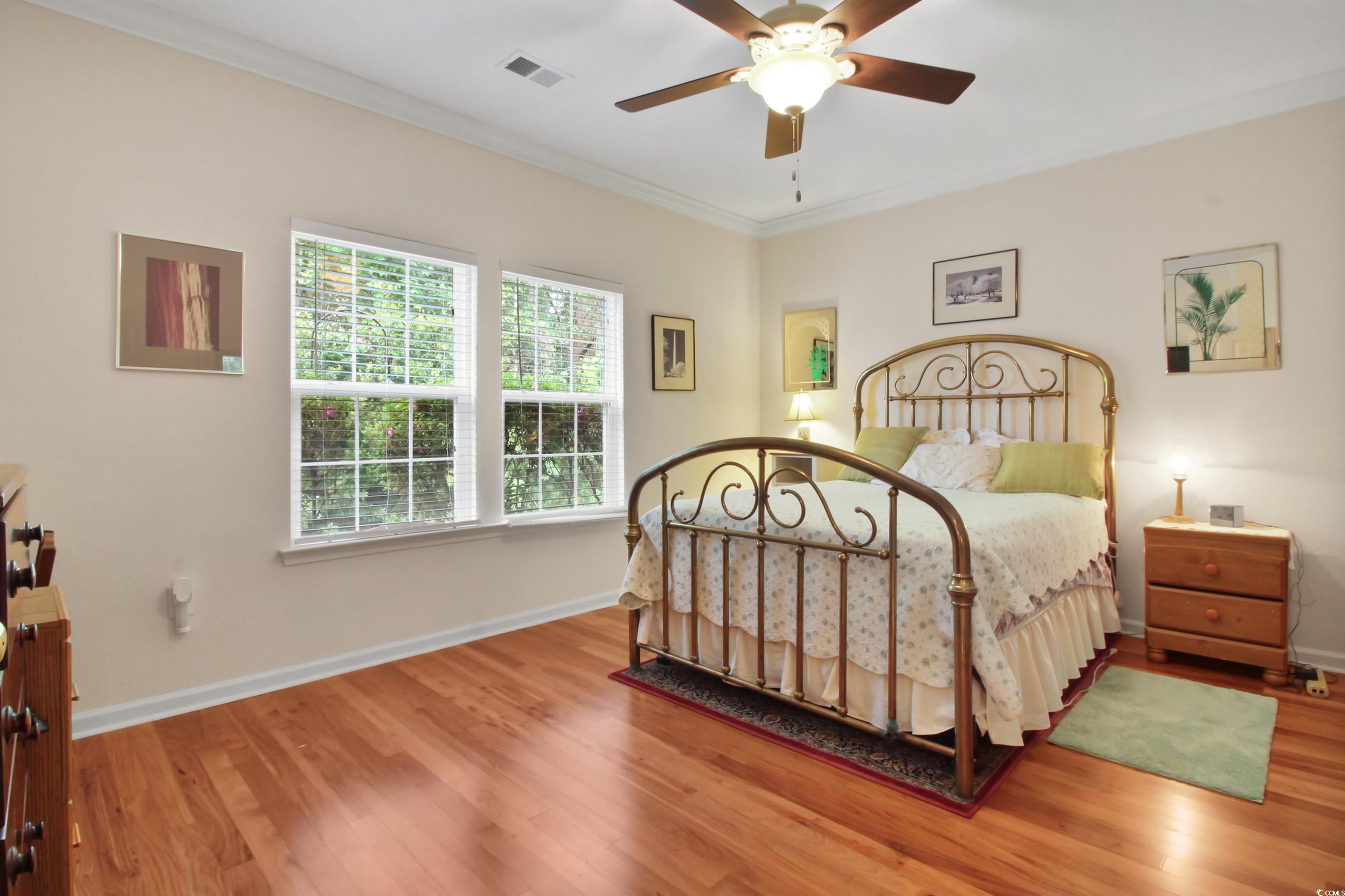 301 Nut Hatch Lane, Unit D Murrells Inlet, SC 29576 - Photo 16 of 40 Bedroom with crown molding, light wood-style flooring, and a ceiling fan