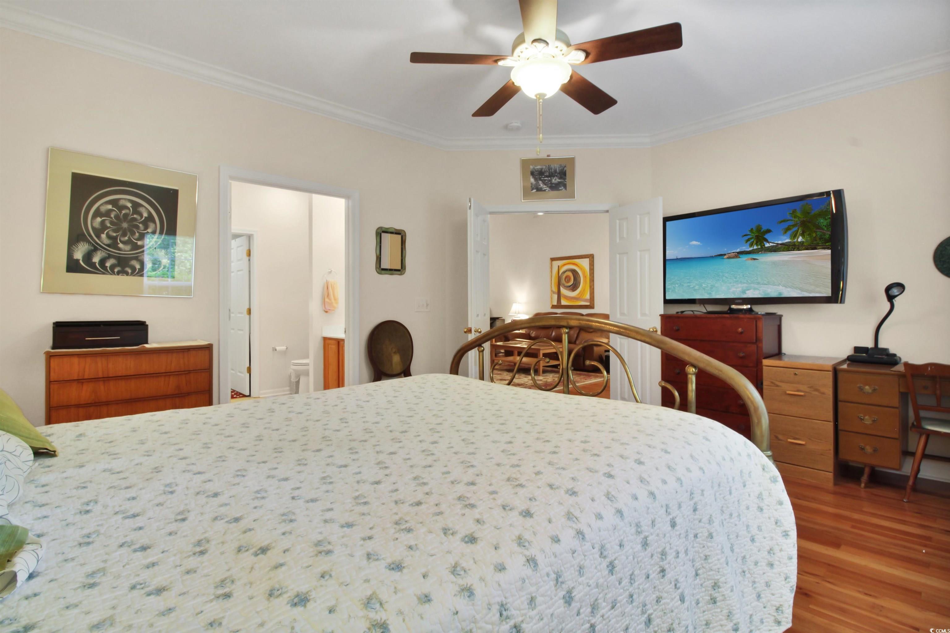 301 Nut Hatch Lane, Unit D Murrells Inlet, SC 29576 - Photo 17 of 40 Bedroom featuring ornamental molding, wood finished floors, and a ceiling fan