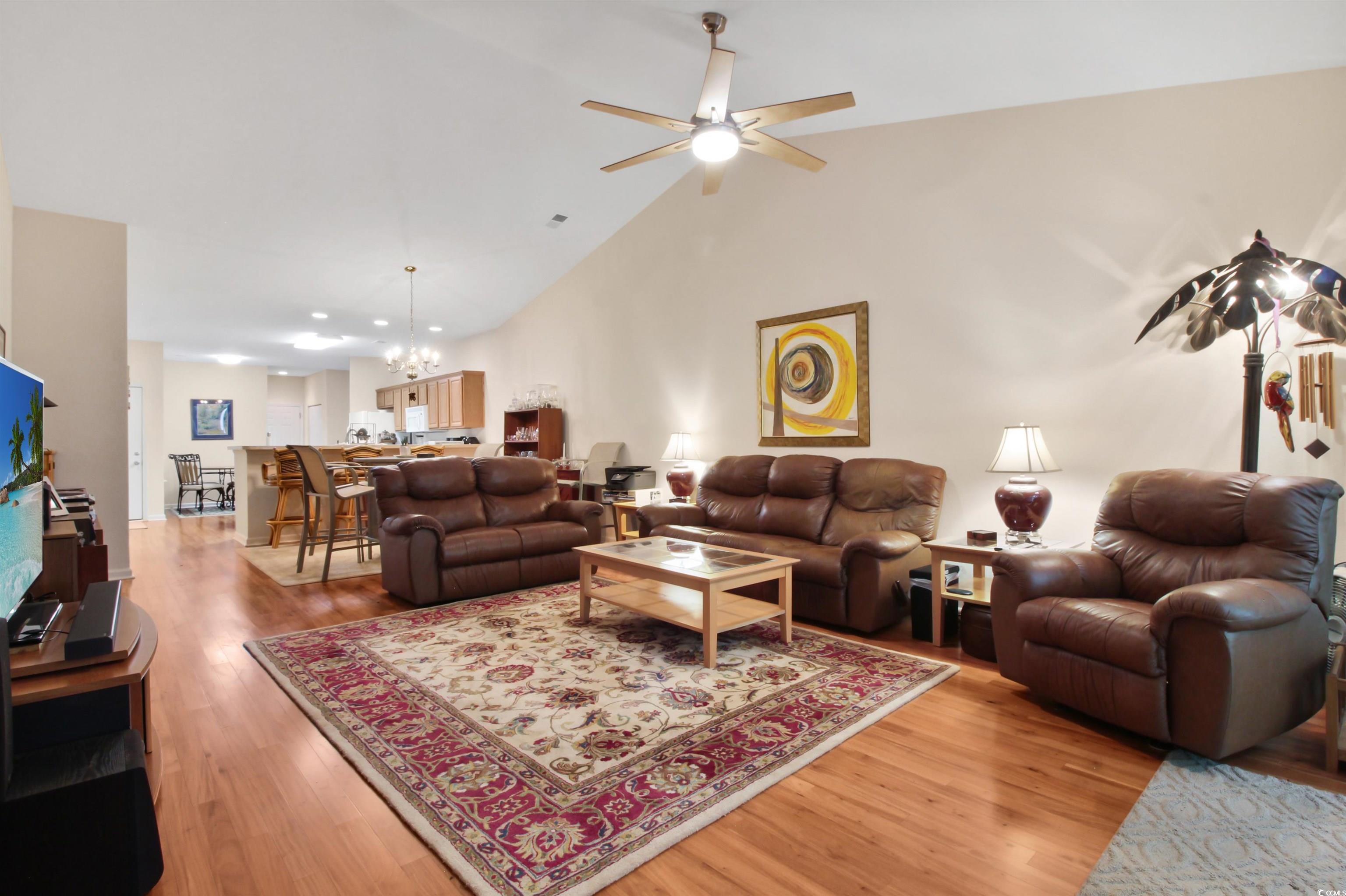 301 Nut Hatch Lane, Unit D Murrells Inlet, SC 29576 - Photo 18 of 40 Living room with high vaulted ceiling, a chandelier, light wood finished floors, and ceiling fan