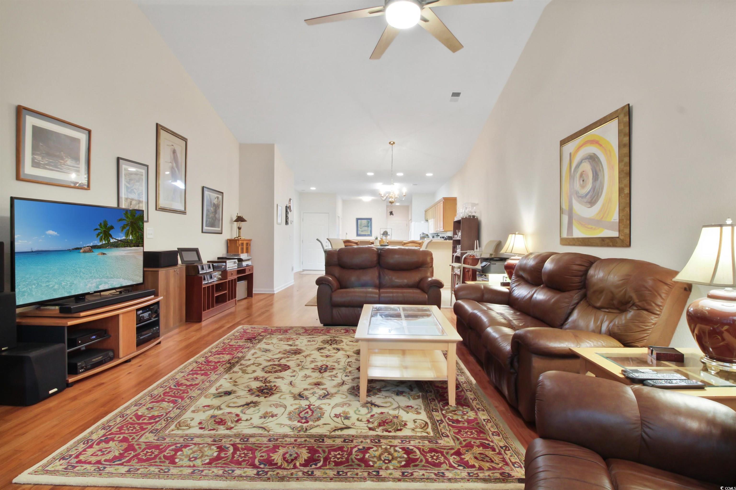 301 Nut Hatch Lane, Unit D Murrells Inlet, SC 29576 - Photo 19 of 40 Living area with light wood-style flooring, a ceiling fan, a chandelier, and high vaulted ceiling