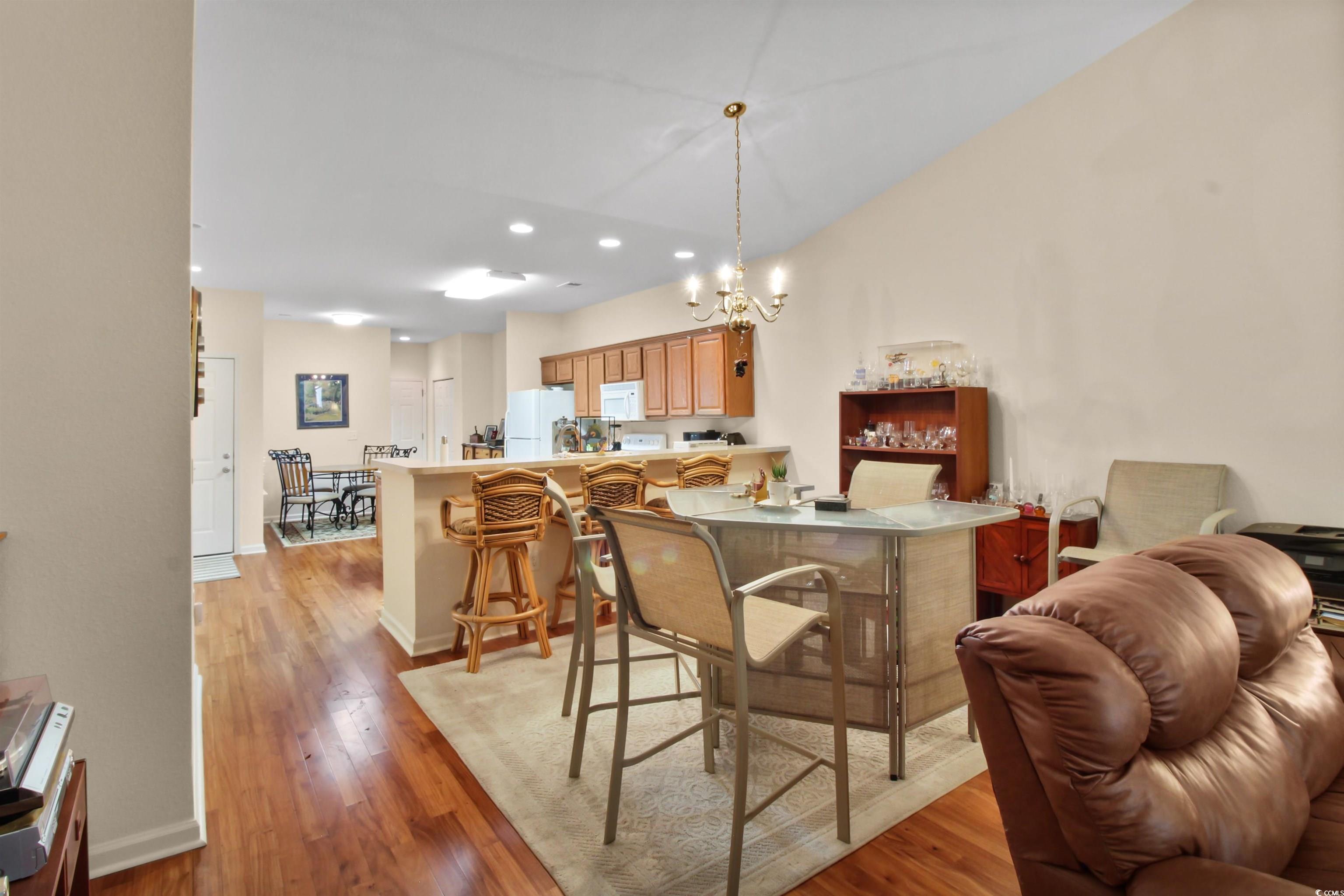 301 Nut Hatch Lane, Unit D Murrells Inlet, SC 29576 - Photo 21 of 40 Dining room with light wood finished floors, a chandelier, and recessed lighting