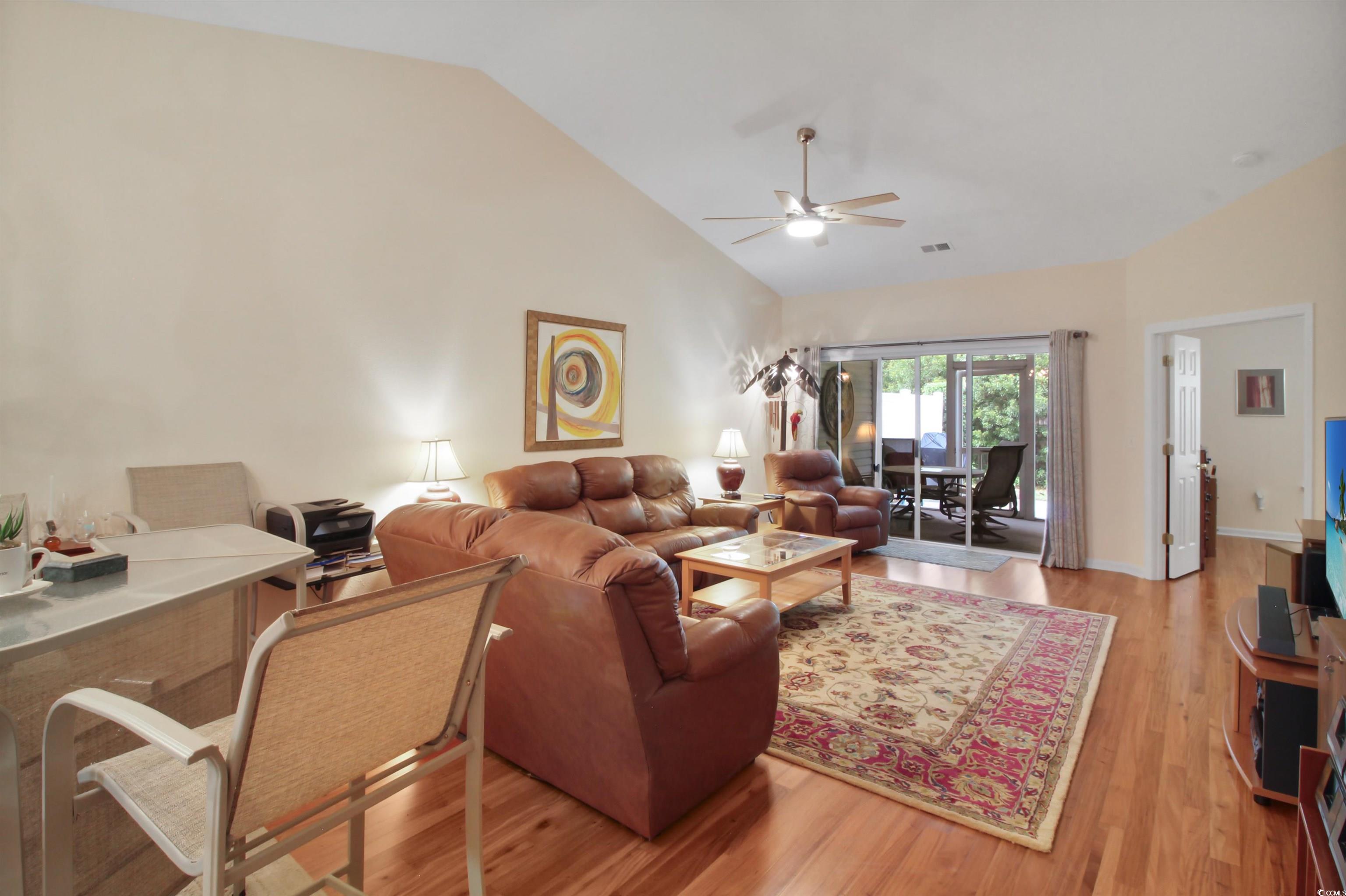 301 Nut Hatch Lane, Unit D Murrells Inlet, SC 29576 - Photo 22 of 40 Living area with light wood-style floors, a ceiling fan, a desk, and high vaulted ceiling