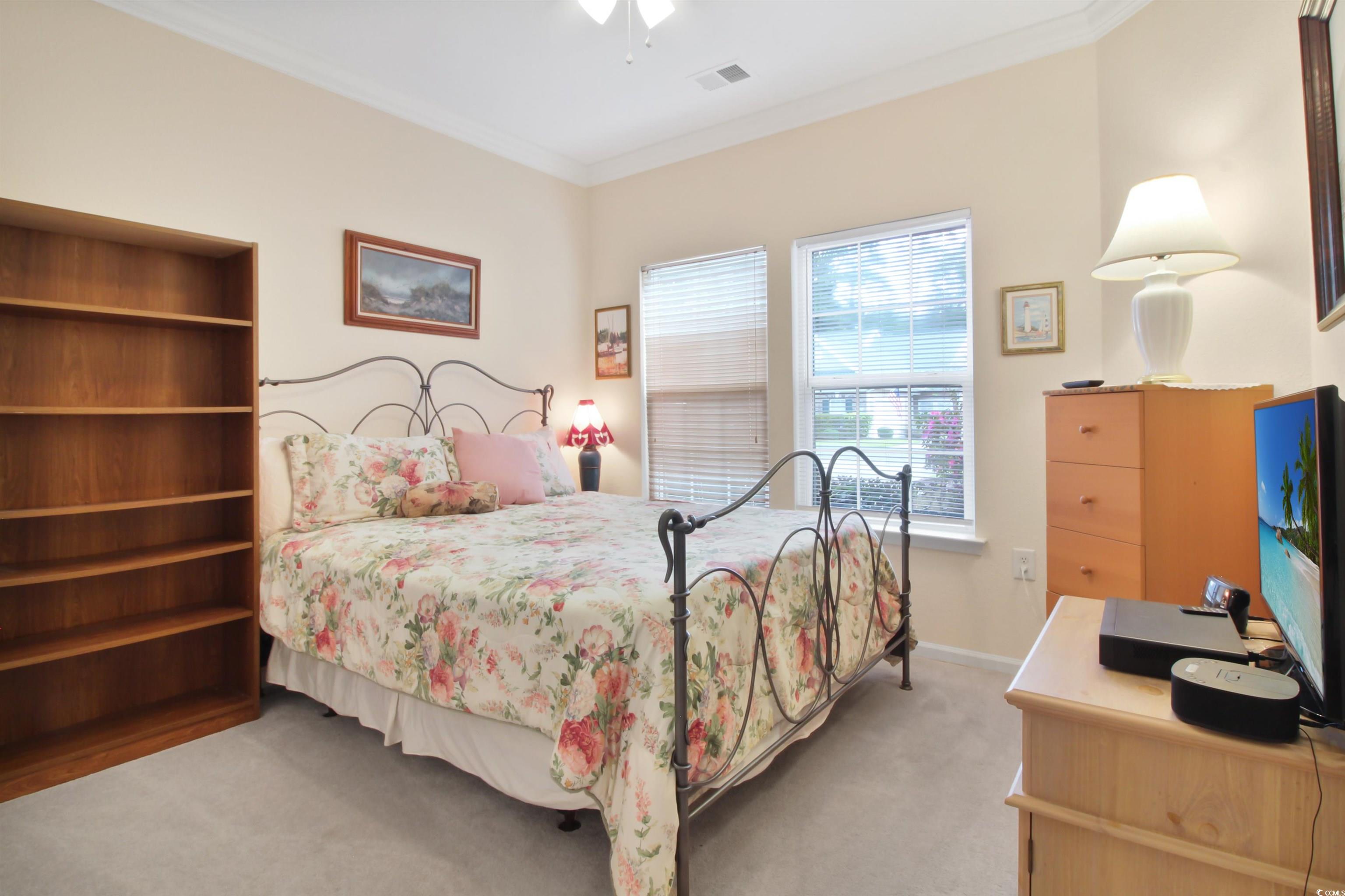 301 Nut Hatch Lane, Unit D Murrells Inlet, SC 29576 - Photo 23 of 40 Bedroom with crown molding, light carpet, and a ceiling fan