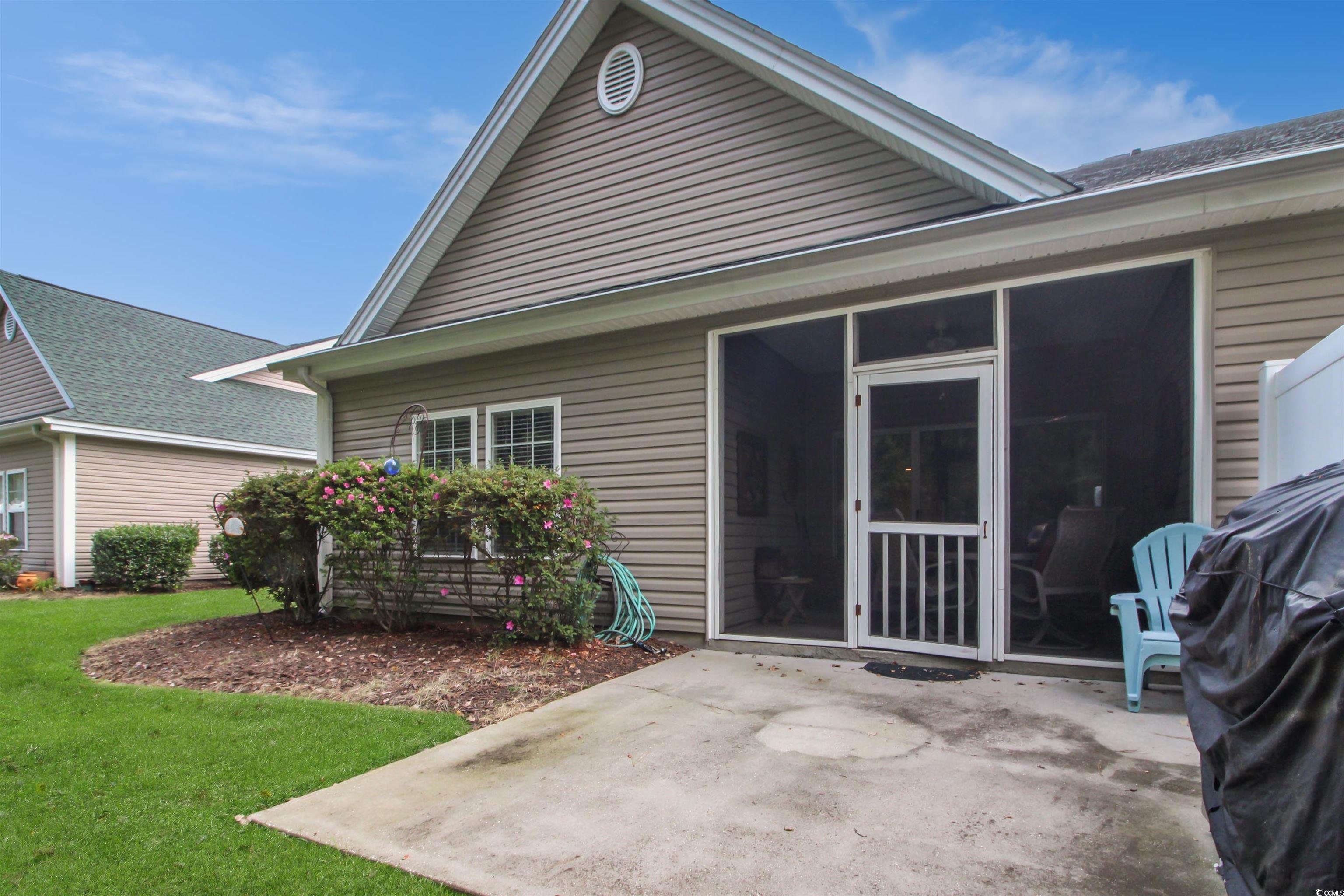 301 Nut Hatch Lane, Unit D Murrells Inlet, SC 29576 - Photo 28 of 40 Back of house with a patio and a yard
