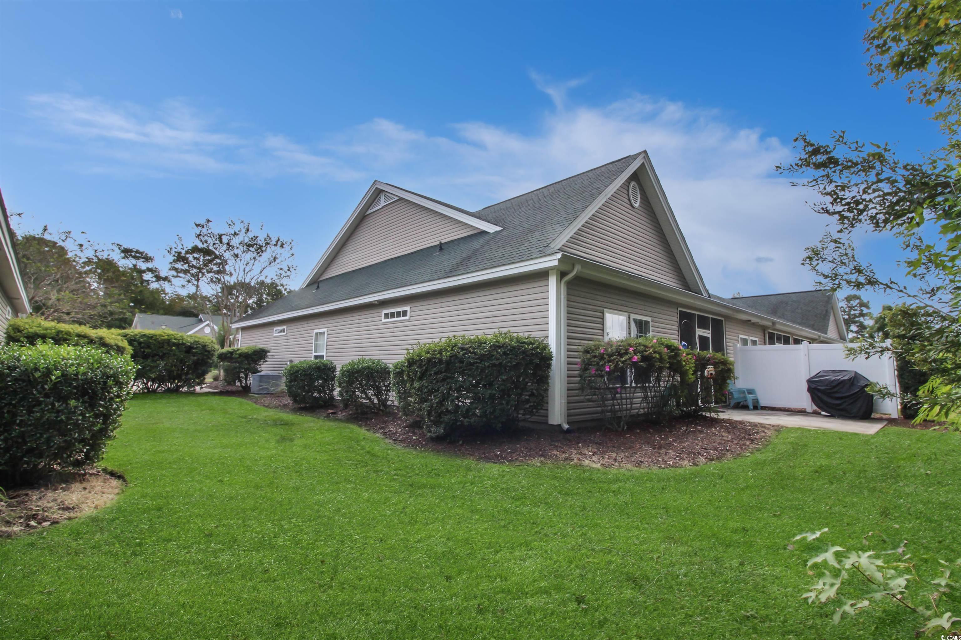 301 Nut Hatch Lane, Unit D Murrells Inlet, SC 29576 - Photo 31 of 40 View of side of property with roof with shingles and a patio