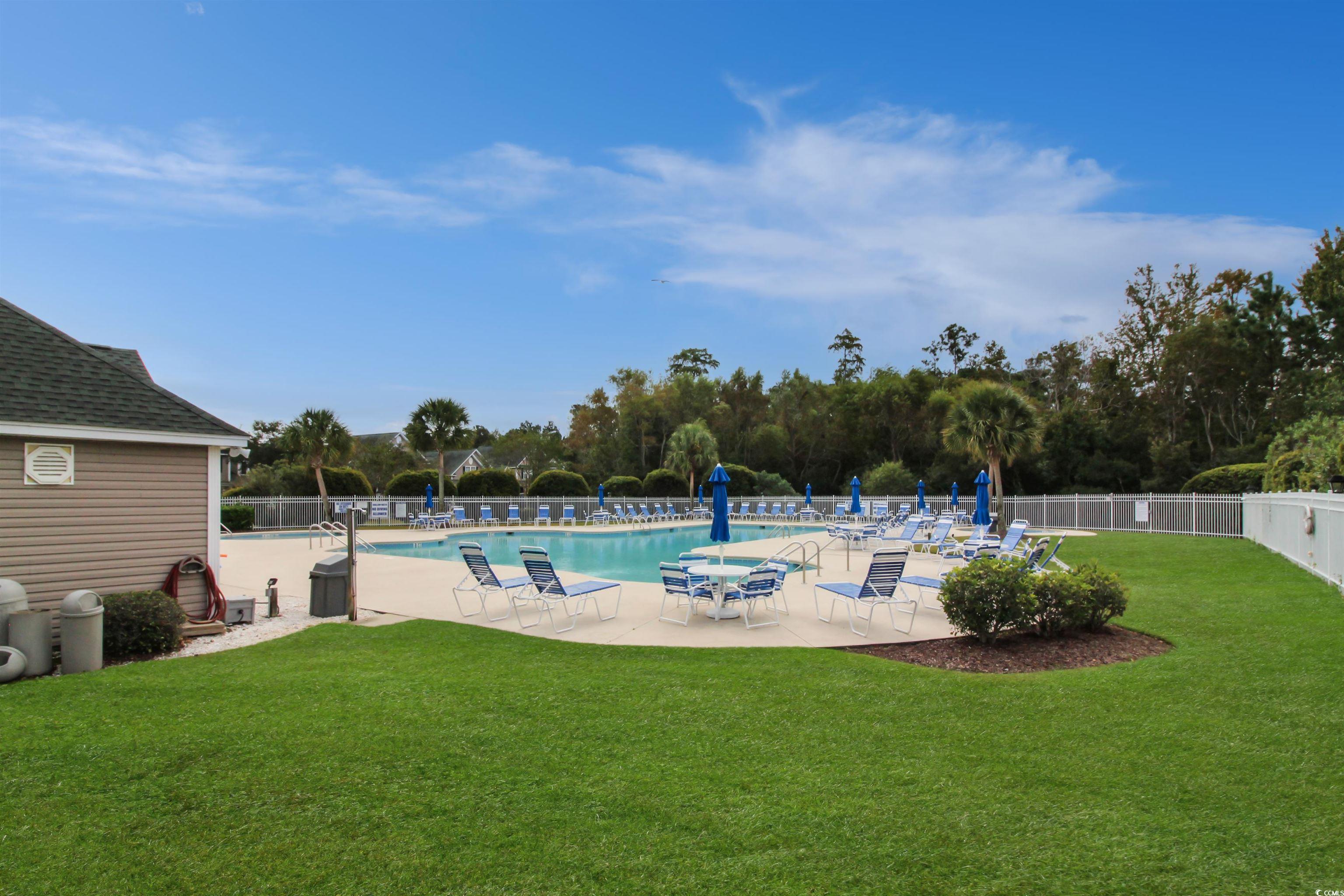 301 Nut Hatch Lane, Unit D Murrells Inlet, SC 29576 - Photo 35 of 40 Community pool with a patio area and view of scattered trees