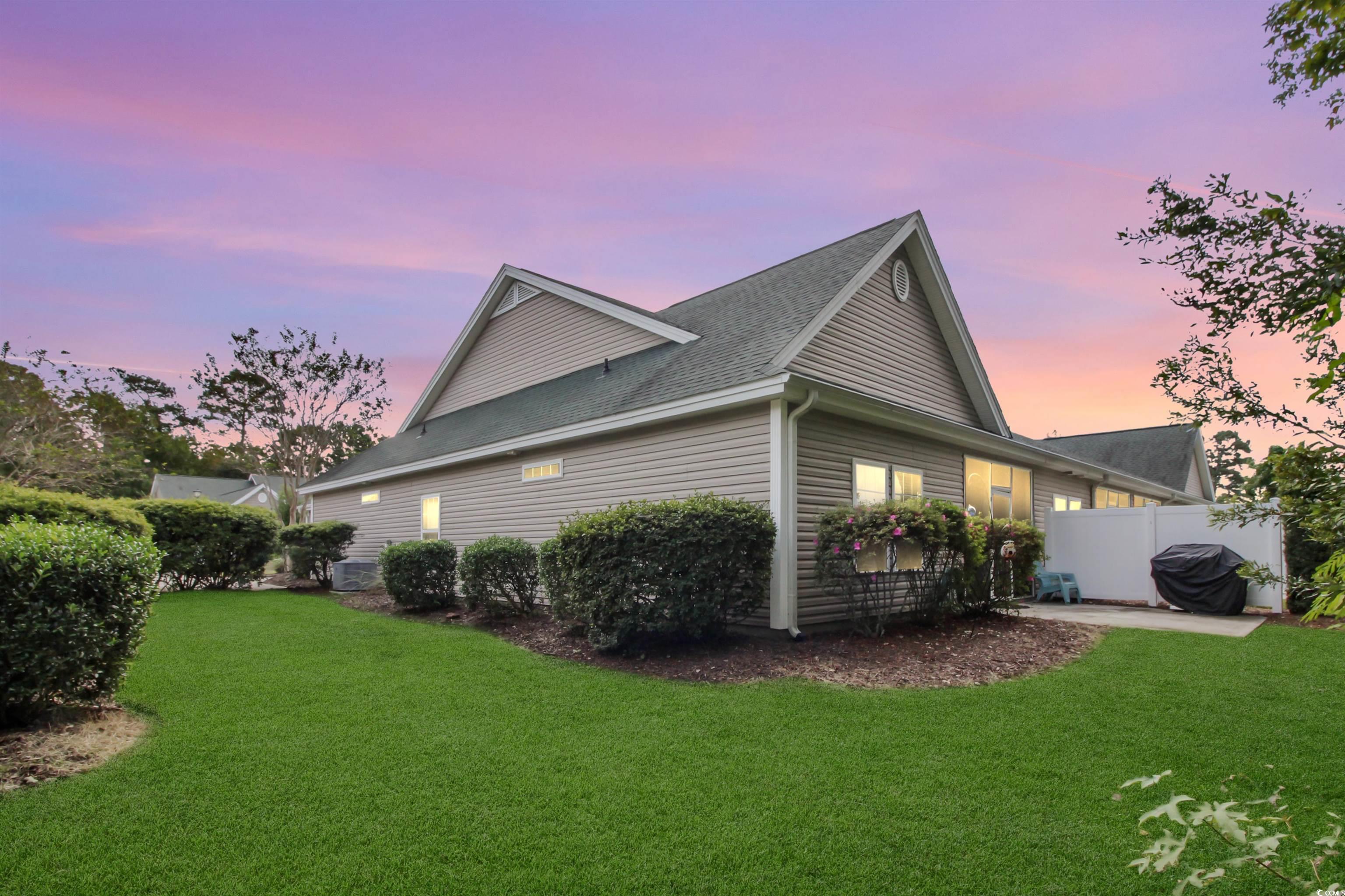 301 Nut Hatch Lane, Unit D Murrells Inlet, SC 29576 - Photo 38 of 40 Property exterior at dusk with a shingled roof