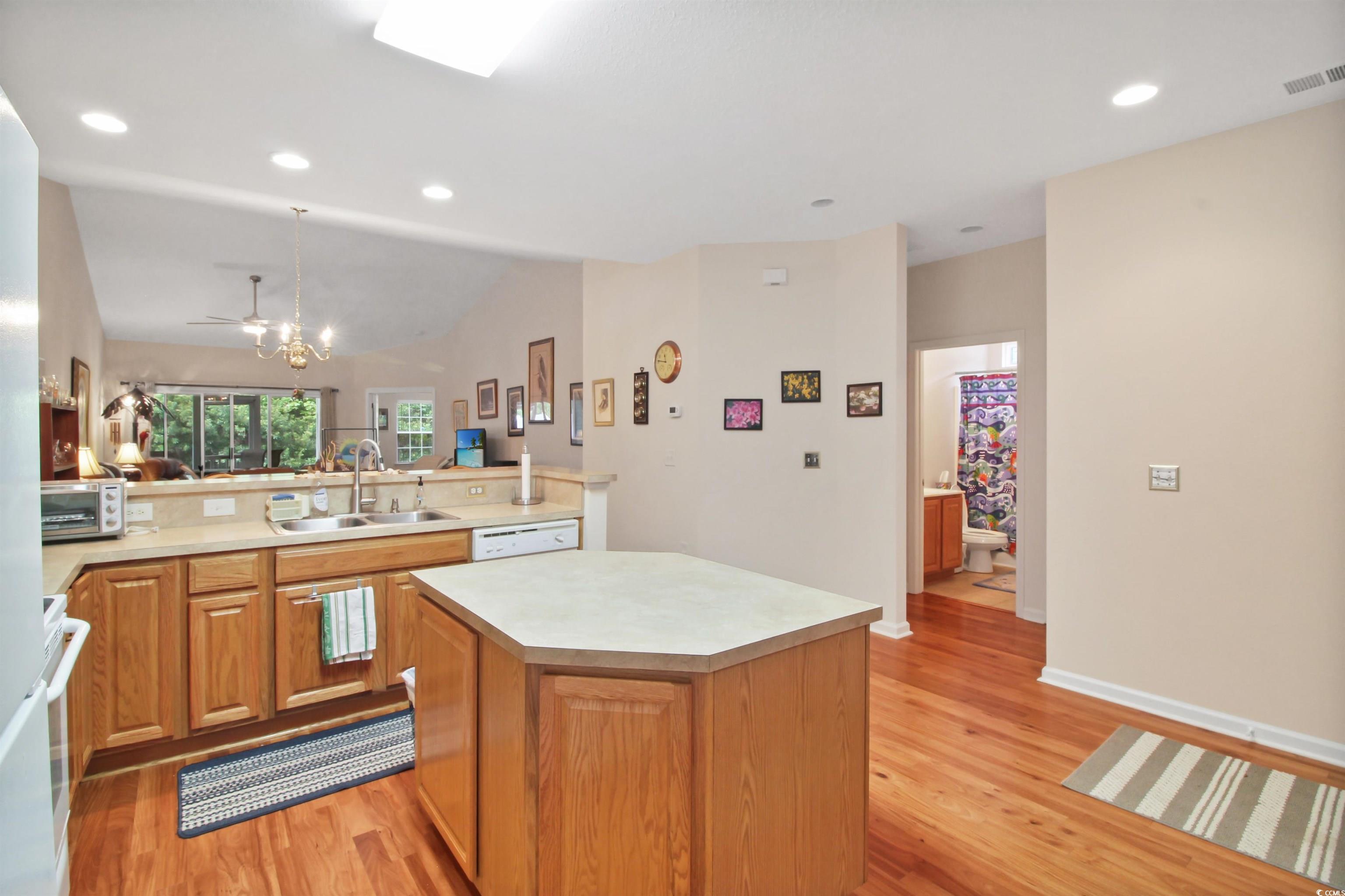 301 Nut Hatch Lane, Unit D Murrells Inlet, SC 29576 - Photo 39 of 40 Kitchen featuring recessed lighting, light wood-style flooring, light countertops, a kitchen island, and open floor plan