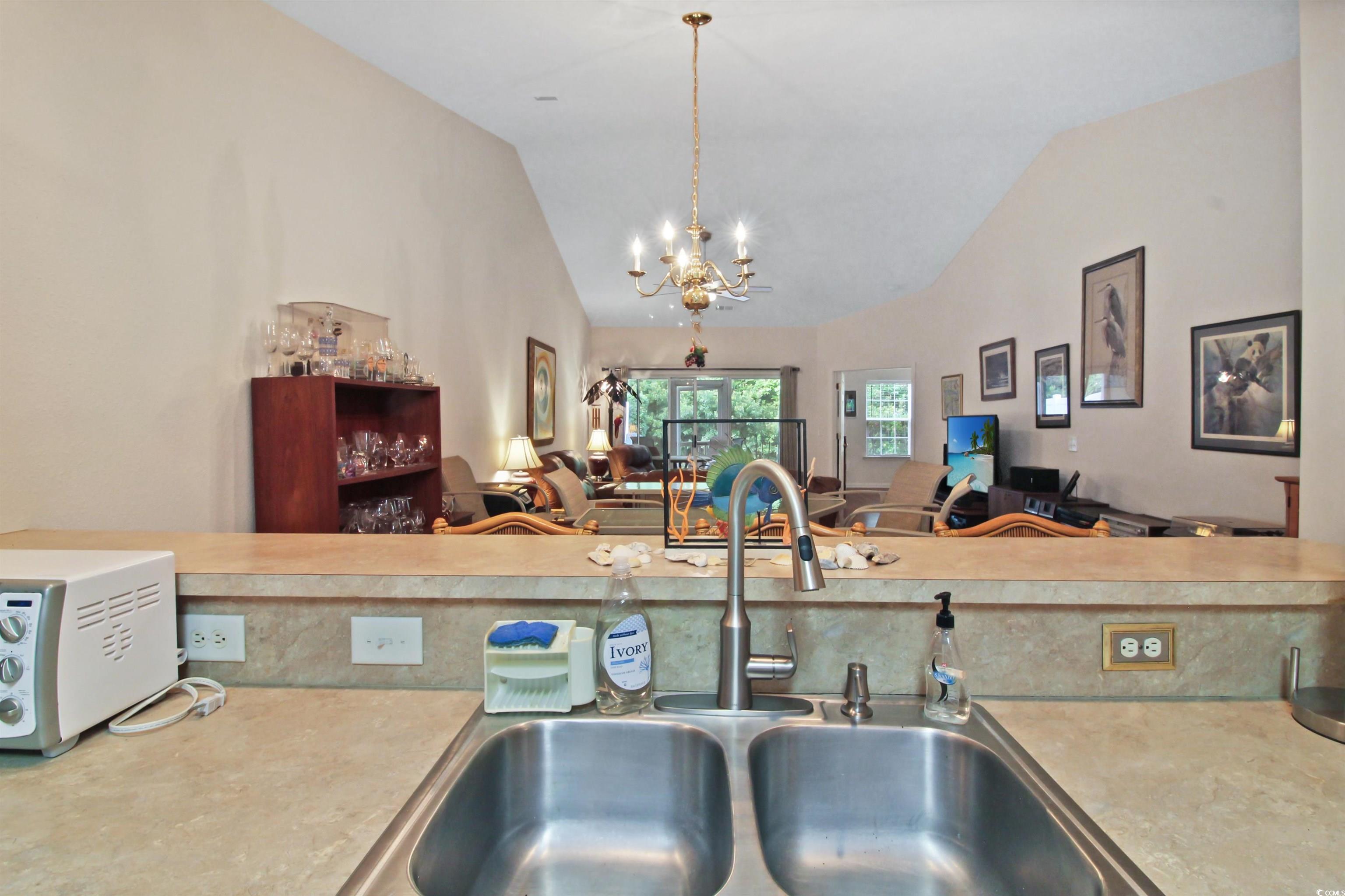 301 Nut Hatch Lane, Unit D Murrells Inlet, SC 29576 - Photo 40 of 40 Kitchen with light countertops, open floor plan, a chandelier, decorative light fixtures, and high vaulted ceiling