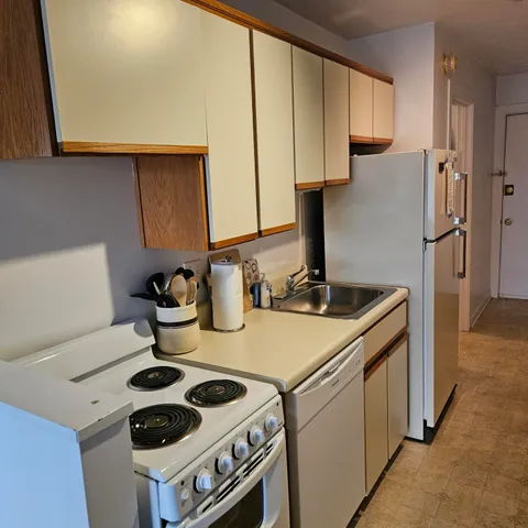 a kitchen with a stove and a refrigerator