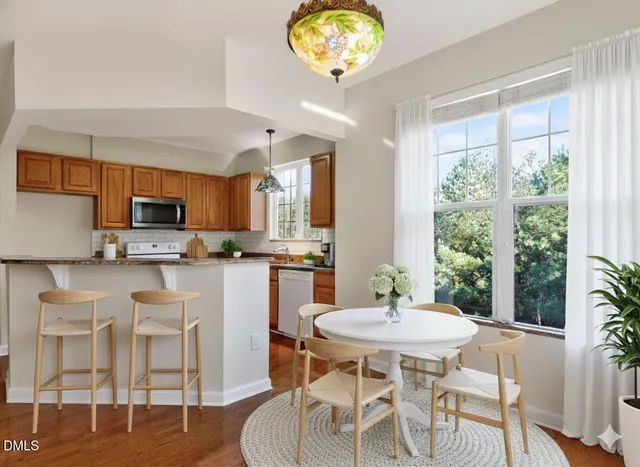 a kitchen with a dining table and chairs