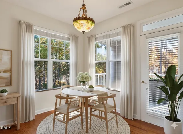 a view of a dining room with furniture window and wooden floor