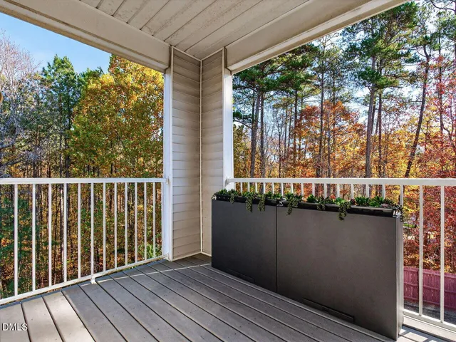 a view of a balcony with wooden floor