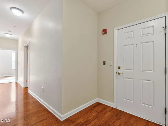 a view of a hallway with wooden floor
