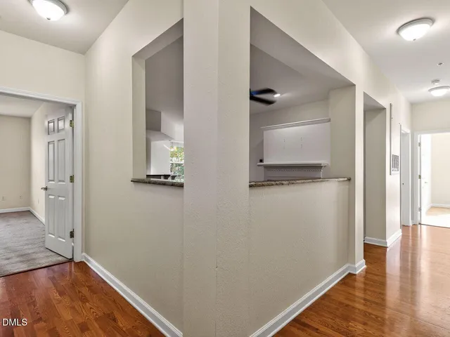 a view of a hallway with wooden floor