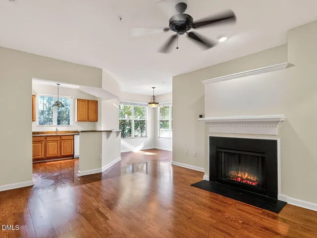 a view of an empty room with exposed radiator and fireplace