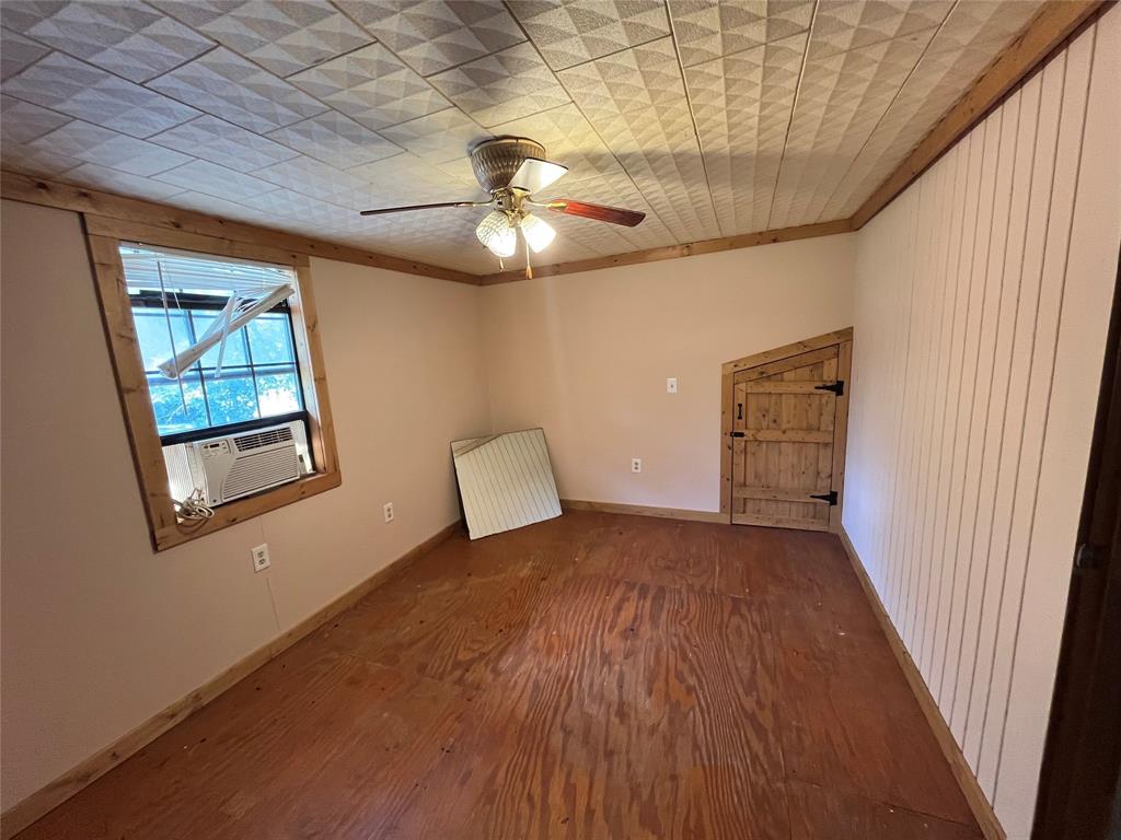 437 Redbud A Groesbeck, TX 76642 - Photo 11 of 18 a view of an empty room with a window and wooden floor