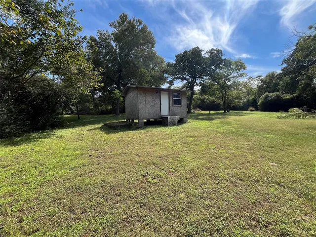 a house with trees in the background