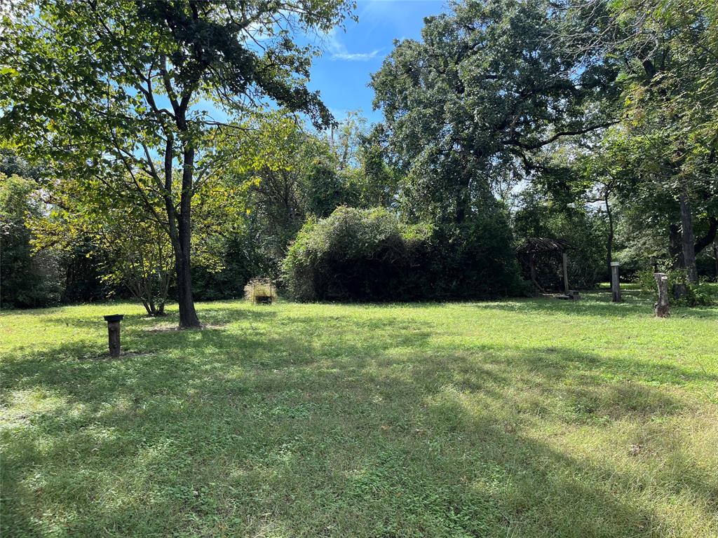 437 Redbud A Groesbeck, TX 76642 - Photo 2 of 18 a green field with lots of trees in the background