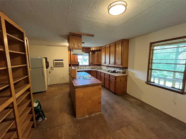 a living room with furniture pool table and large windows