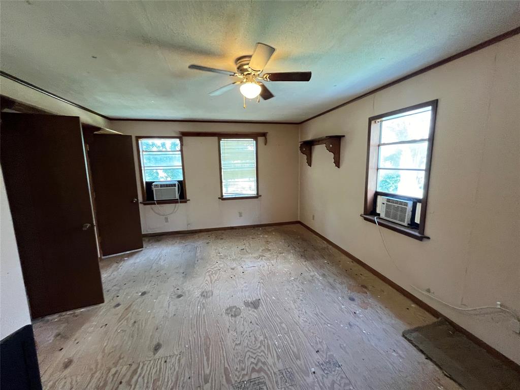437 Redbud A Groesbeck, TX 76642 - Photo 10 of 18 wooden floor in an empty room with a window