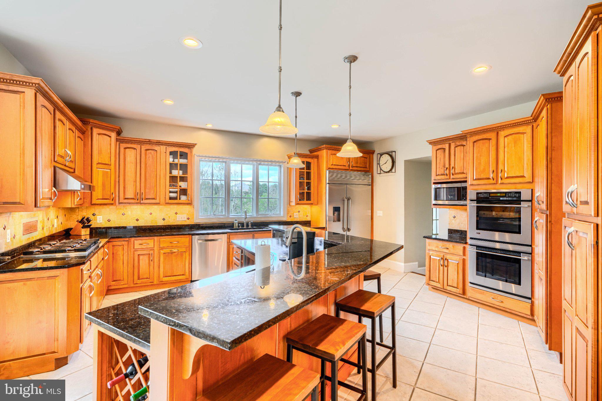 2415 Old Bosley Road Lutherville-Timonium, MD 21093 - Photo 12 of 65 a kitchen with stainless steel appliances granite countertop a sink a stove and a refrigerator