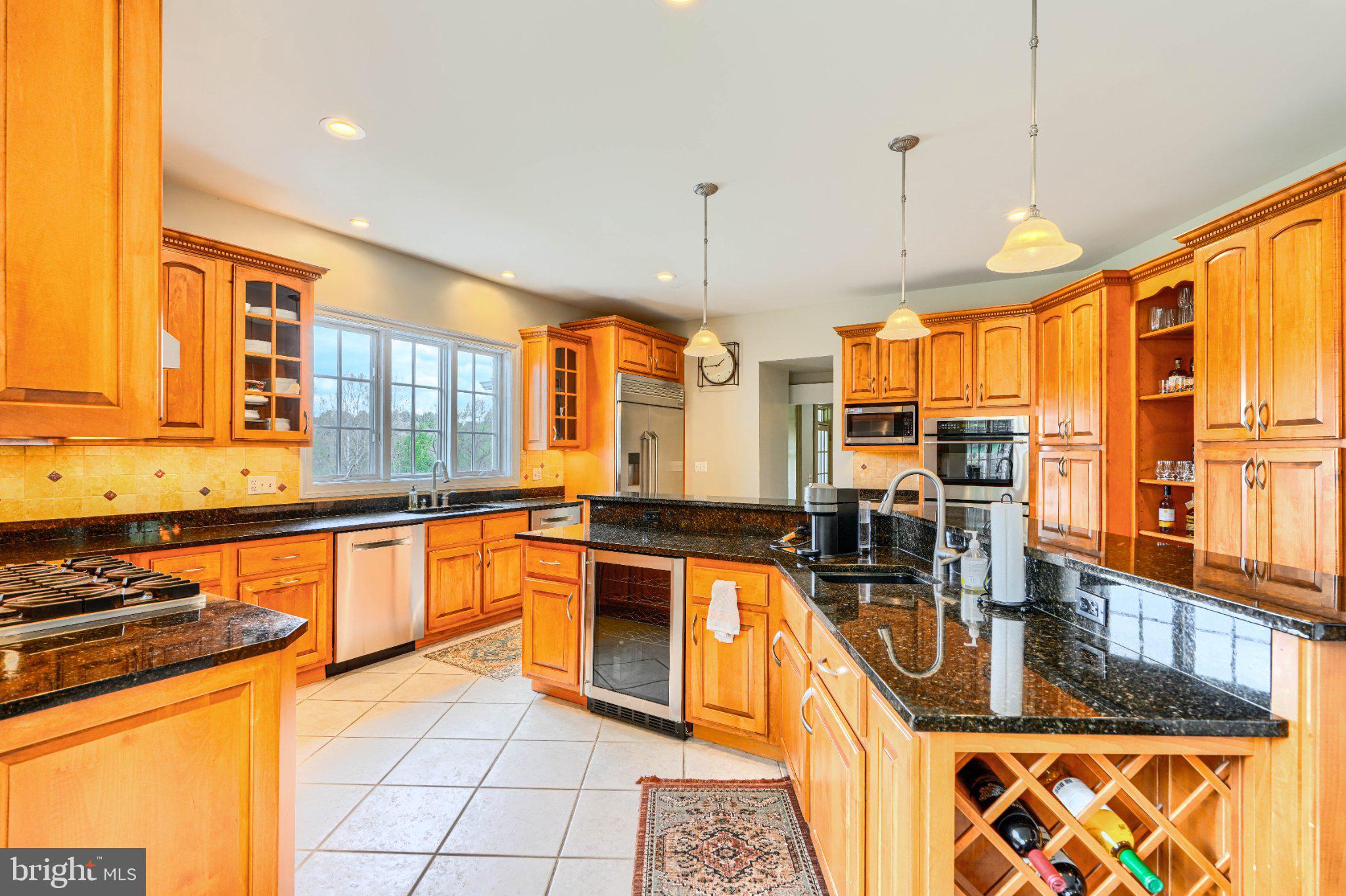 2415 Old Bosley Road Lutherville-Timonium, MD 21093 - Photo 13 of 65 a kitchen with stainless steel appliances granite countertop a stove a sink and a microwave
