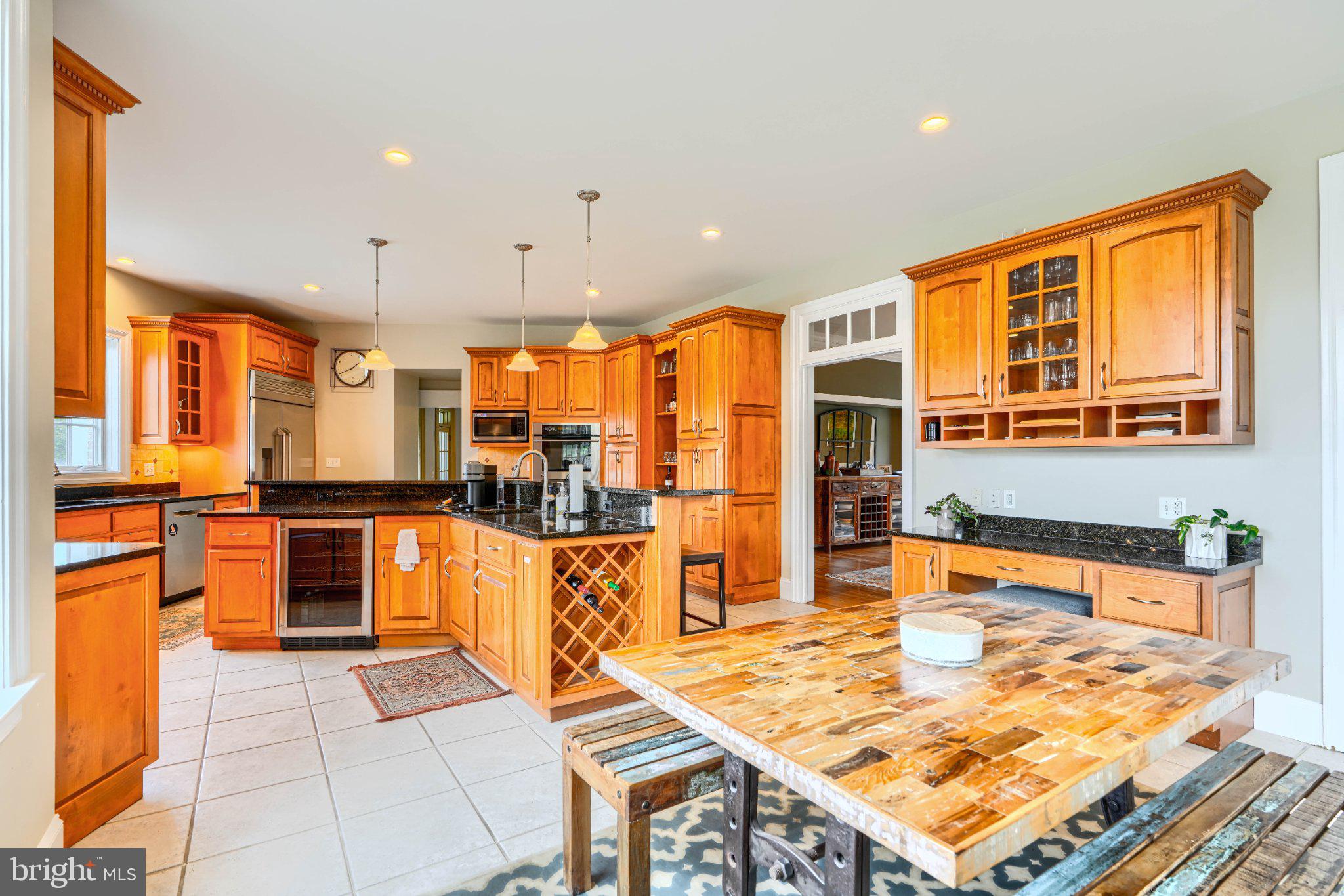 2415 Old Bosley Road Lutherville-Timonium, MD 21093 - Photo 14 of 65 a large kitchen with stainless steel appliances granite countertop a stove a sink and dishwasher a oven with large cabinets
