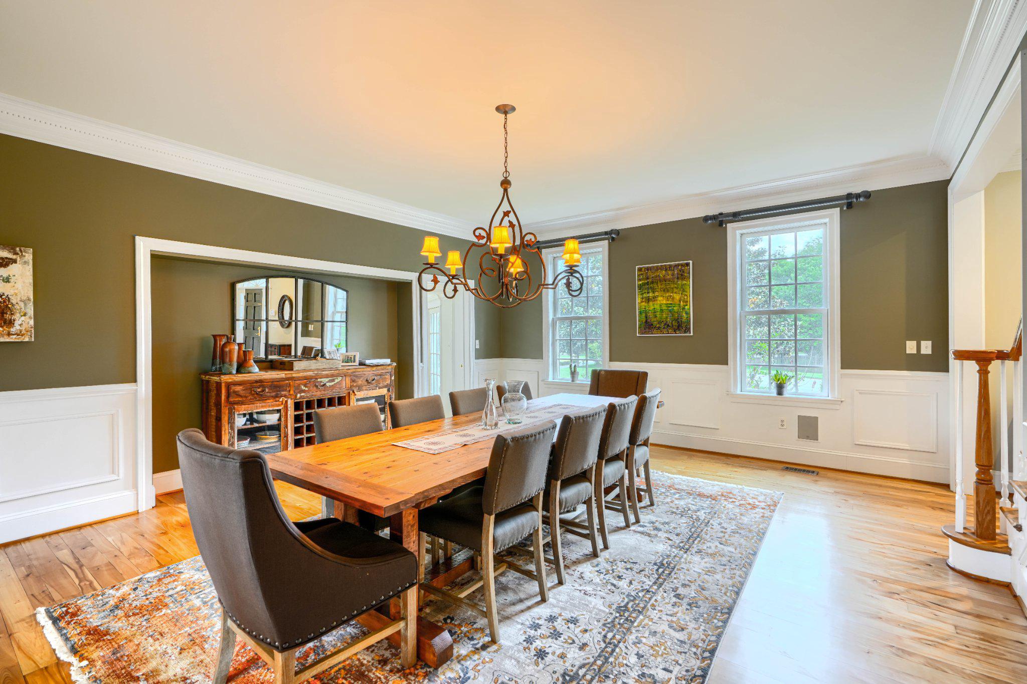 2415 Old Bosley Road Lutherville-Timonium, MD 21093 - Photo 17 of 65 a dining room with wooden floor a chandelier a wooden table and chairs