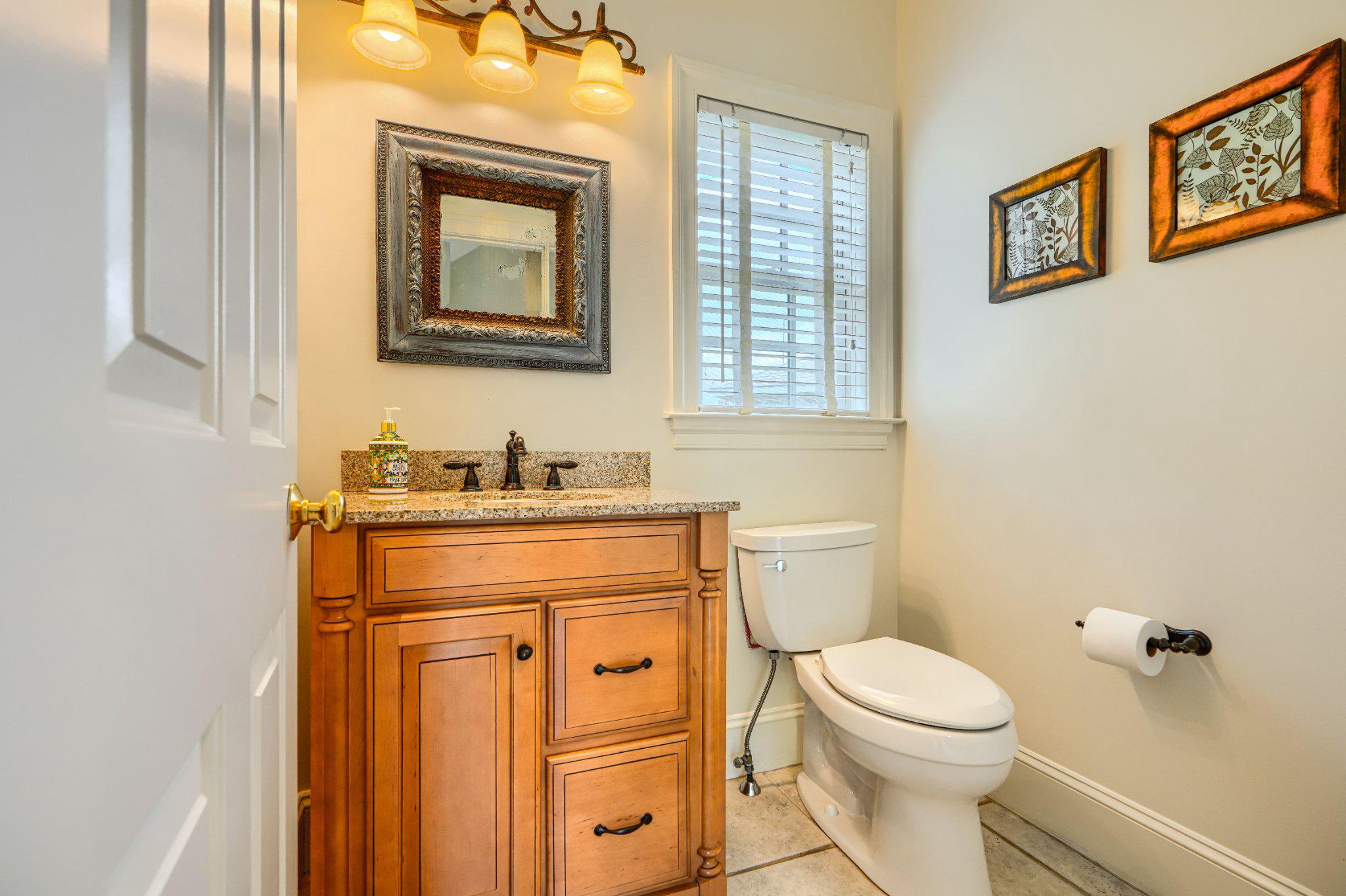 2415 Old Bosley Road Lutherville-Timonium, MD 21093 - Photo 28 of 65 a bathroom with a granite countertop toilet sink and mirror