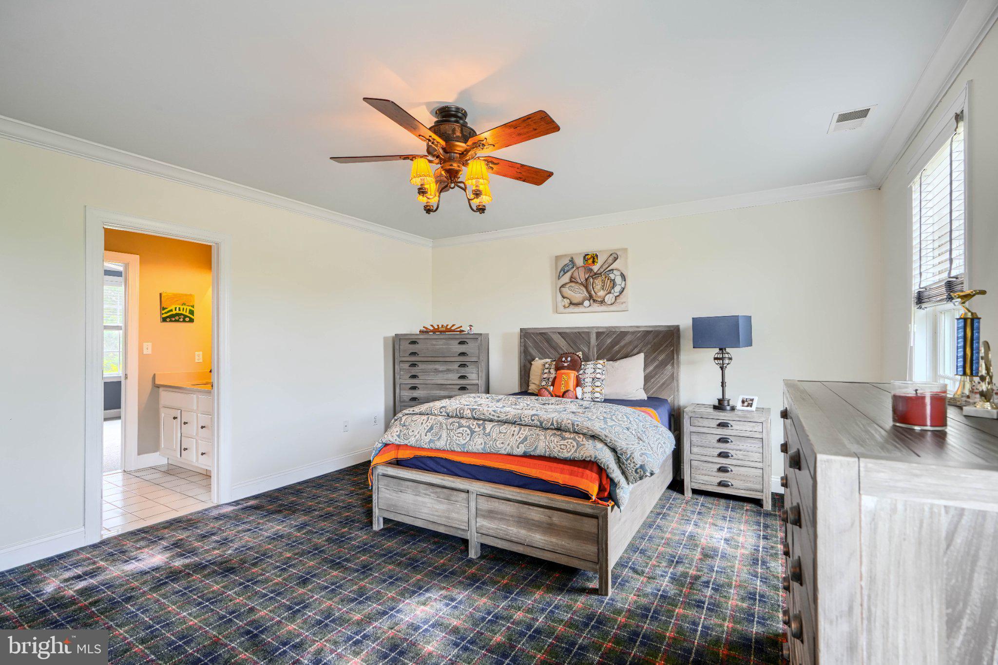 2415 Old Bosley Road Lutherville-Timonium, MD 21093 - Photo 34 of 65 a bedroom with a bed and a chandelier