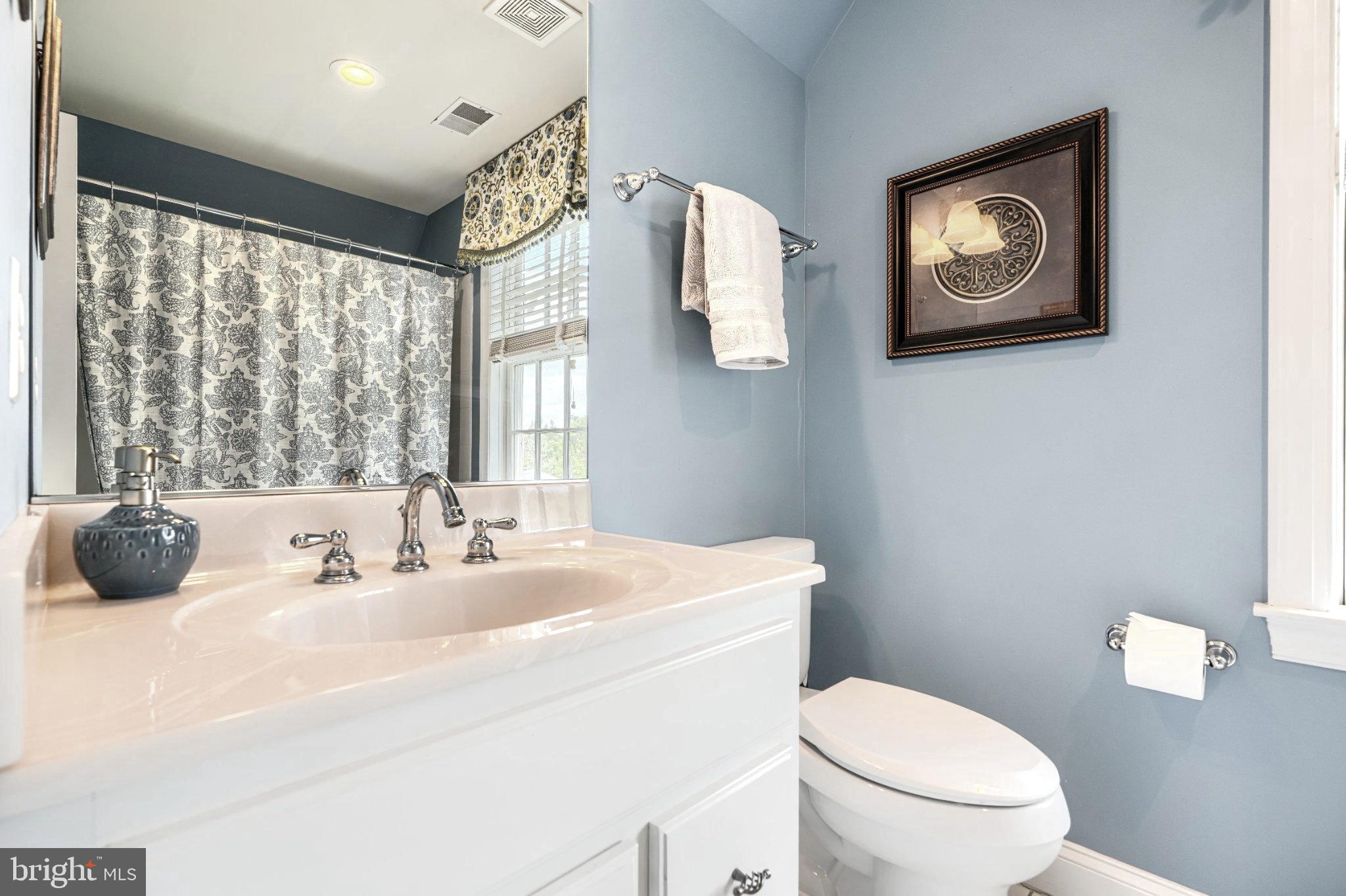 2415 Old Bosley Road Lutherville-Timonium, MD 21093 - Photo 41 of 65 a bathroom with a toilet a sink and mirror