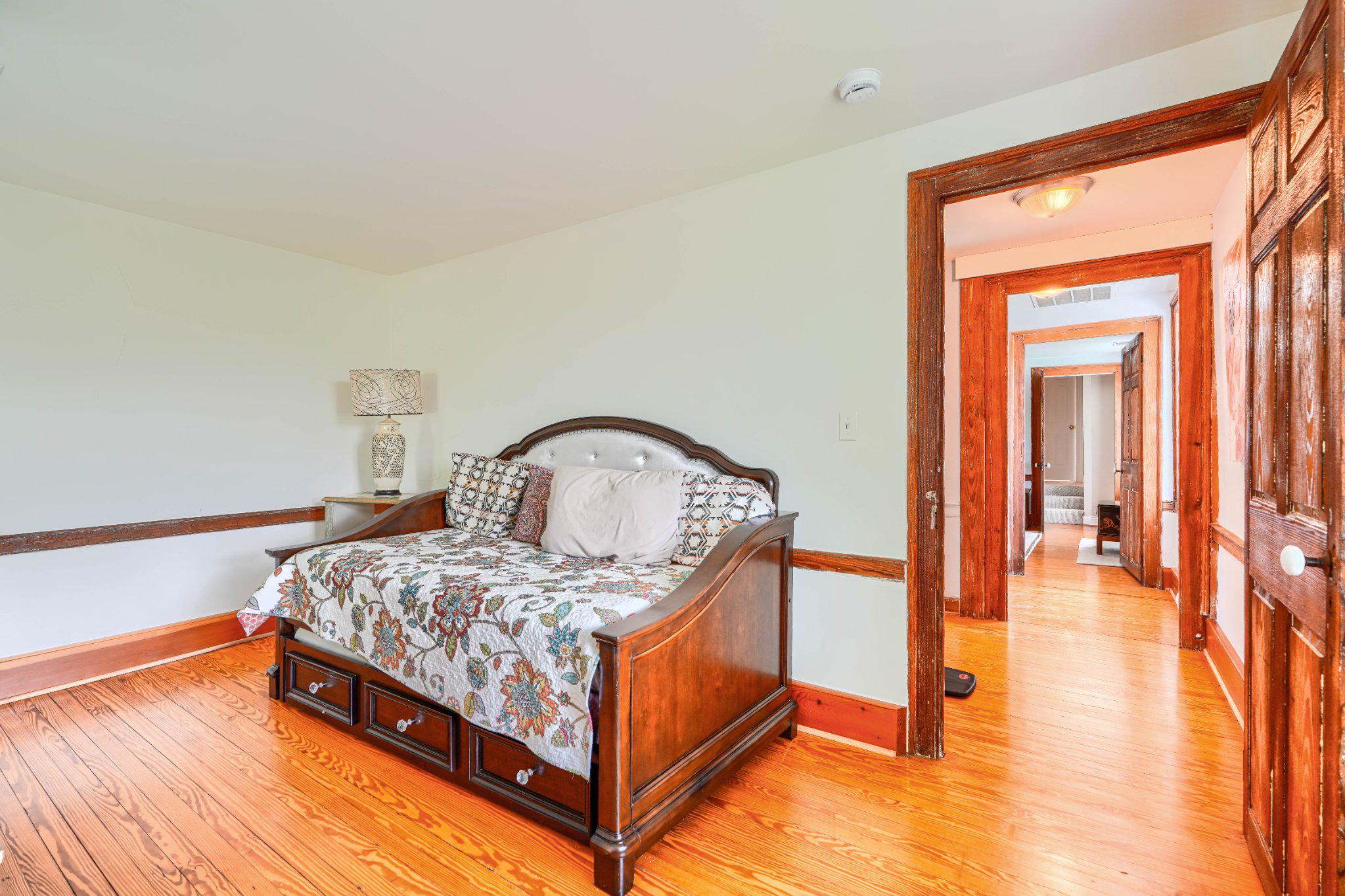 2415 Old Bosley Road Lutherville-Timonium, MD 21093 - Photo 42 of 65 a bedroom with a bed and a chandelier