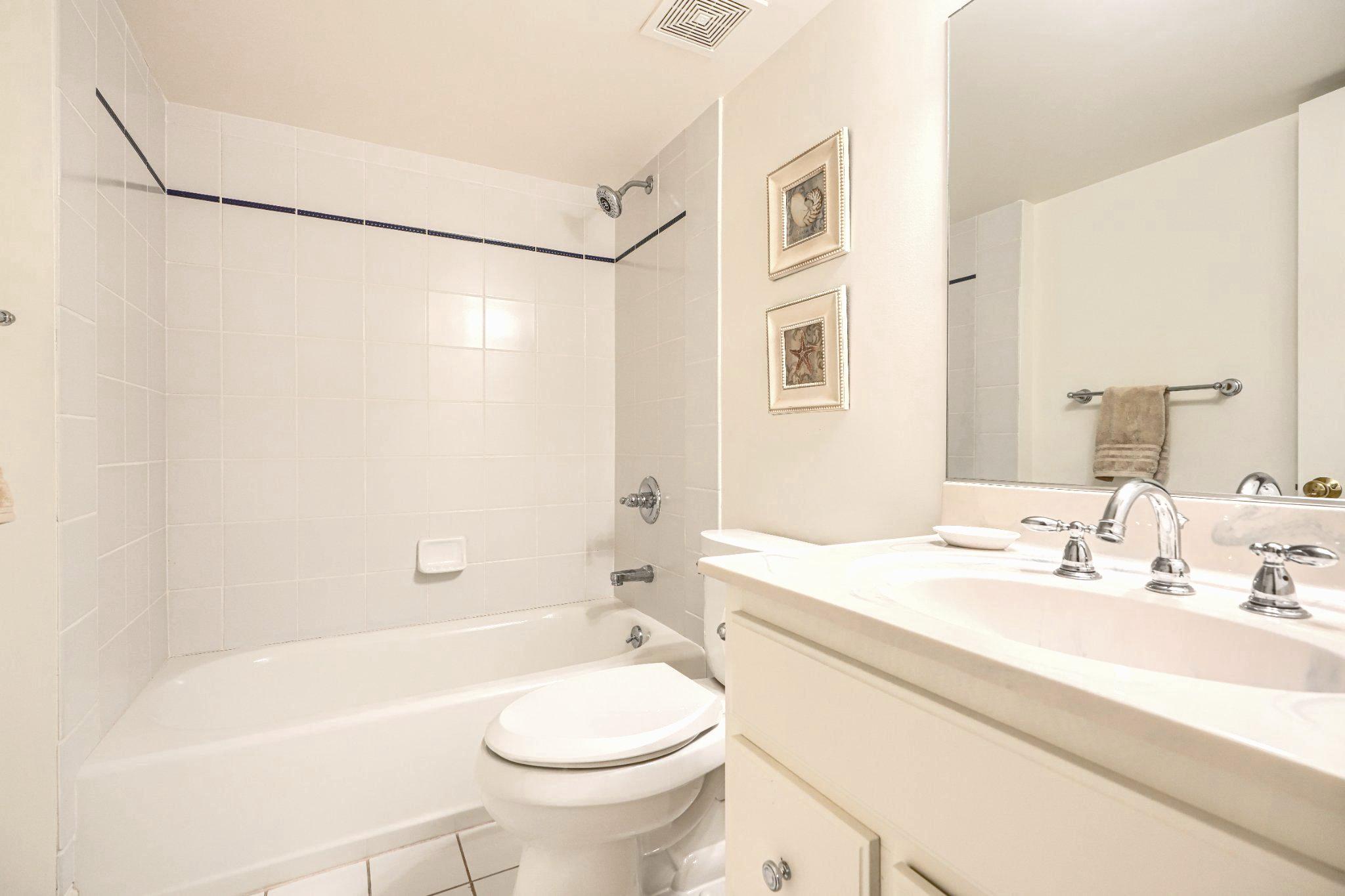 2415 Old Bosley Road Lutherville-Timonium, MD 21093 - Photo 51 of 65 a bathroom with a sink a toilet a mirror a bathtub and shower