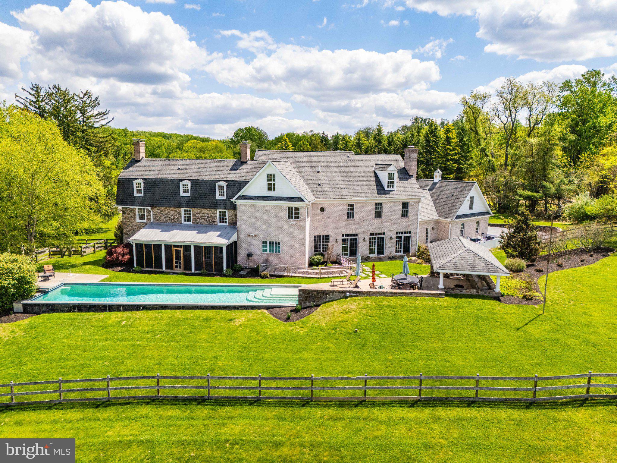 2415 Old Bosley Road Lutherville-Timonium, MD 21093 - Photo 62 of 65 a view of a swimming pool with lawn chairs and large trees