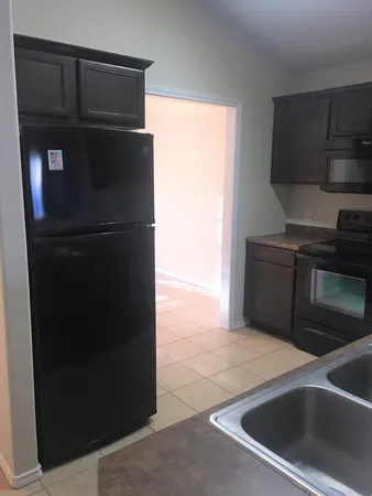 a kitchen with a refrigerator and a sink