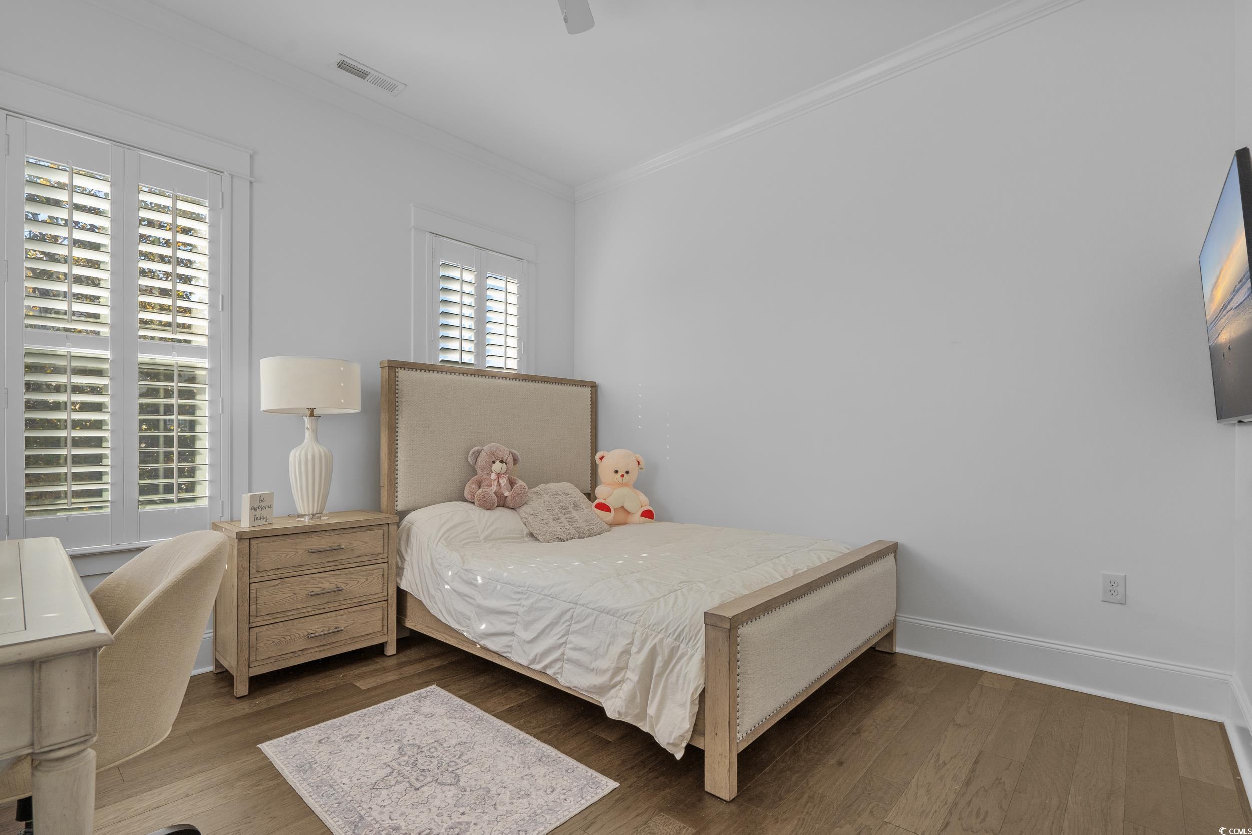 927 Iris Street Myrtle Beach, SC 29577 - Photo 29 of 40 Bedroom with wood finished floors, ornamental molding, and a ceiling fan