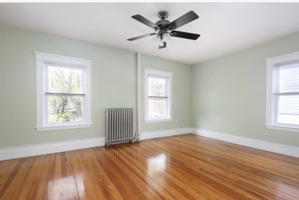 22 Winslow Road Brookline, MA 02446 - Photo 7 of 10 a view of an empty room with wooden floor and a window