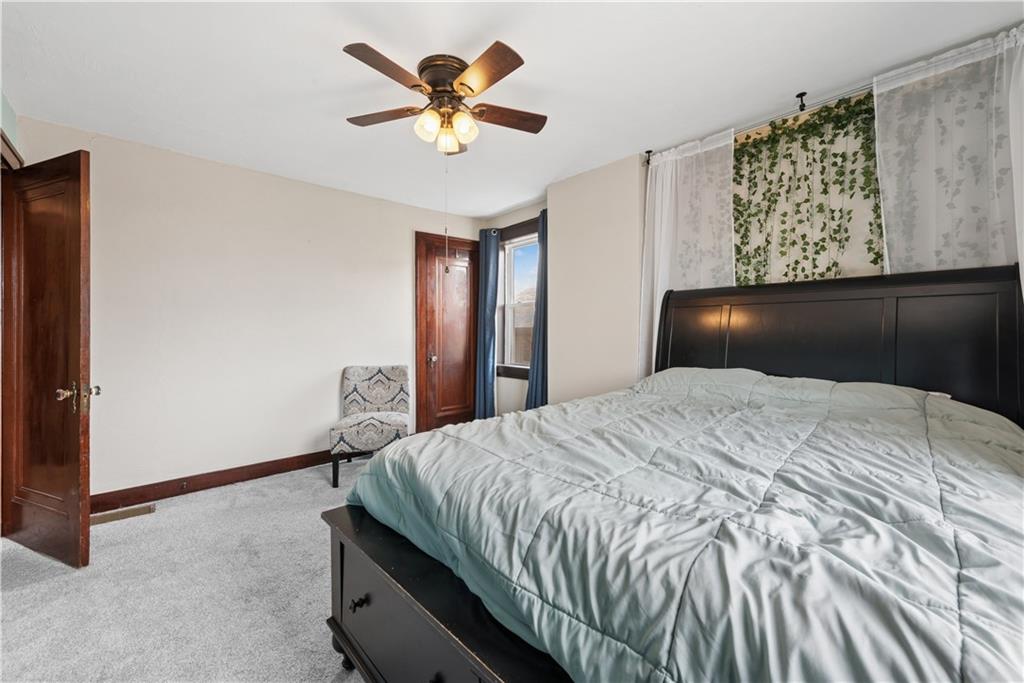 53 Calhoun Avenue Pittsburgh, PA 15210 - Photo 15 of 30 a bedroom with a bed and a chandelier