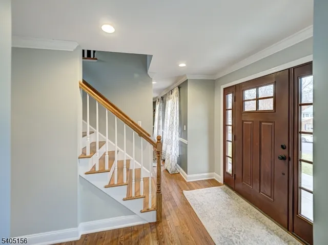 a view of entryway and hall with wooden floor