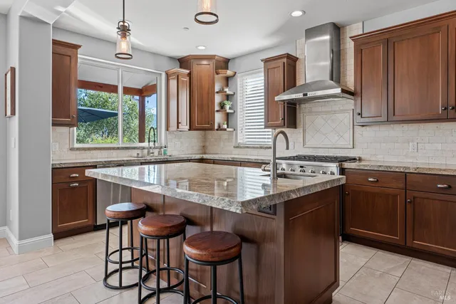 a kitchen with granite countertop a sink and a stove