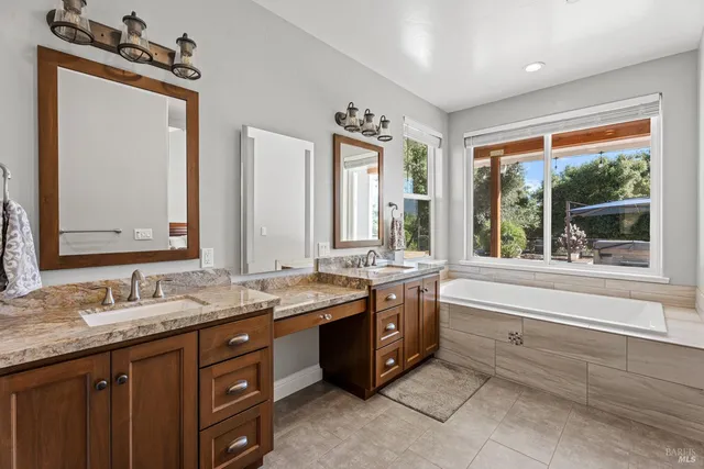 a large bathroom with double vanity and a large mirror
