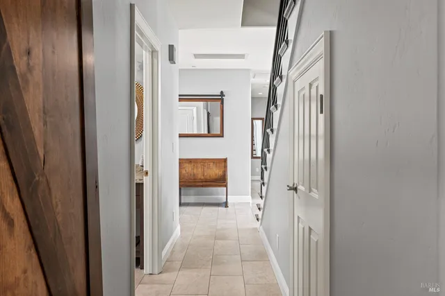a view of a hallway with wooden floor and staircase