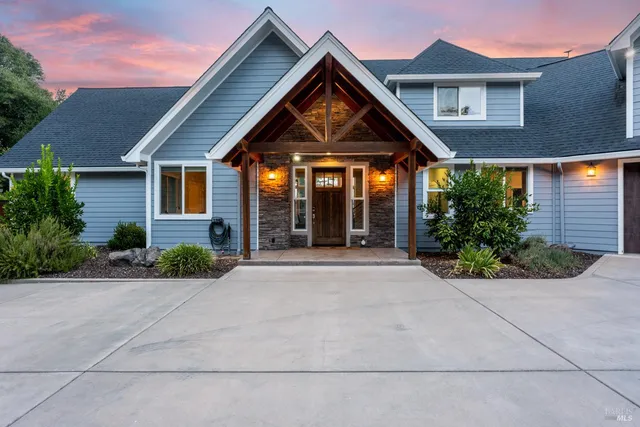 a front view of a house with garden