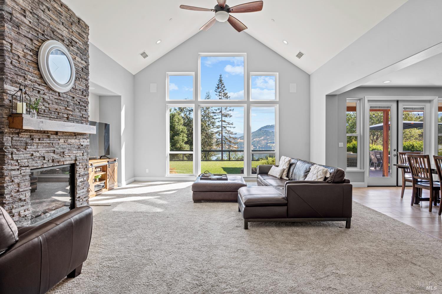 4561 Lake Ridge Road Ukiah, CA 95482 - Photo 4 of 52 a living room with furniture a fireplace and a large window