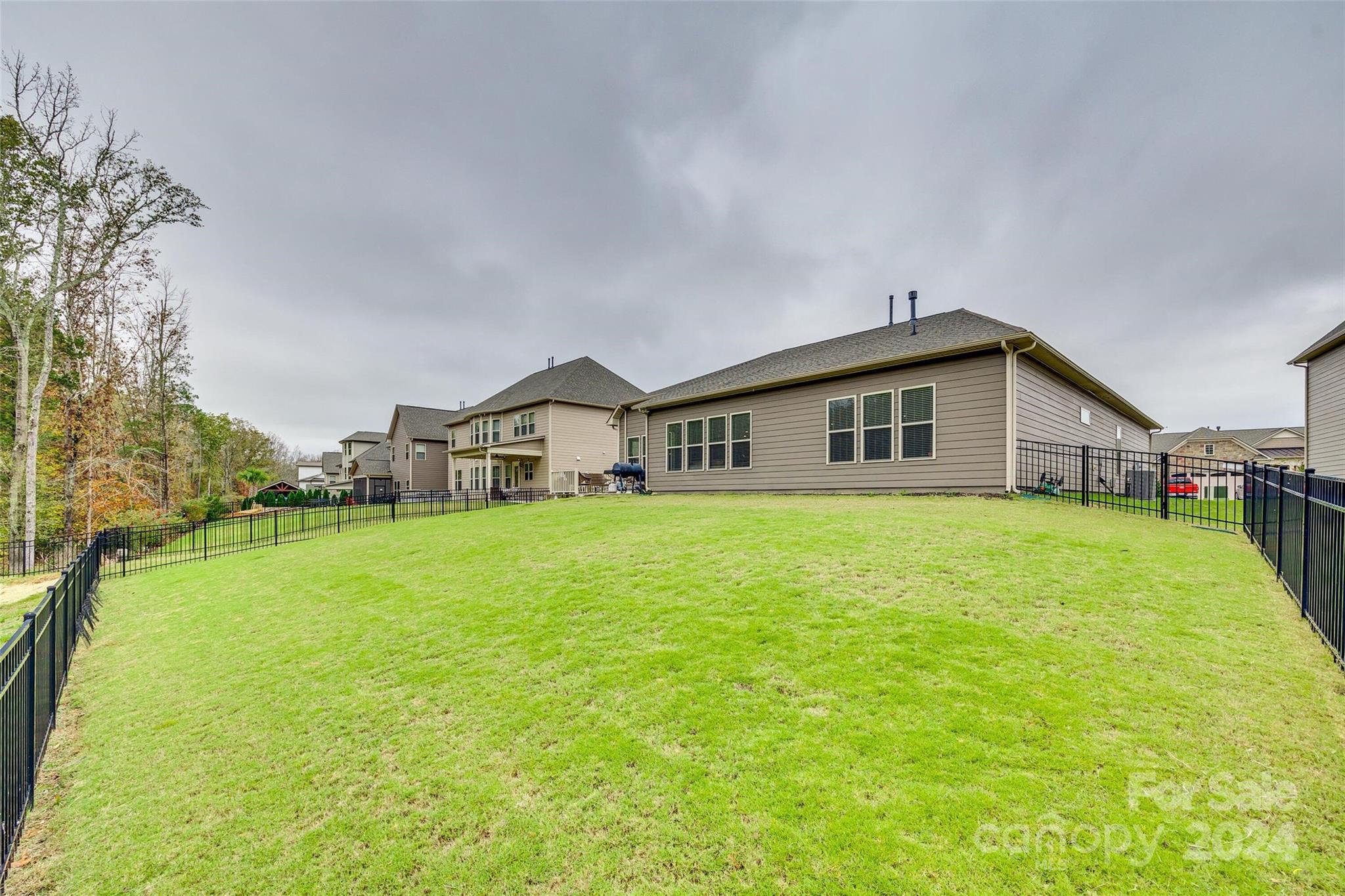 1156 Castle Road Fort Mill, SC 29707 - Photo 7 of 34 a front view of house with yard and trees in the background